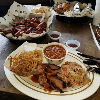 The Bone - Two meats platter. Brisket and pull pork with onion straws and beans. We also tried the honey bourbon wings... delicious!!! - Barbeque Near Me - Manassas, Virginia The Bone - Two meats platter. Brisket and pull pork with onion straws and beans. We also tried the honey bourbon wings... delicious!!! - Barbeque Near Me - Manassas, Virginia