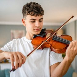 Teen boy playing violin
