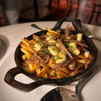 Alouette Bistro - HH duck poutine - triple cooked fries, confit duck, duck gravy, cheese, herbs 12 - French Near Me - Vancouver, British Columbia Alouette Bistro - HH duck poutine - triple cooked fries, confit duck, duck gravy, cheese, herbs 12 - French Near Me - Vancouver, British Columbia