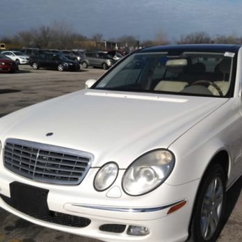 Lee's Auto Clinic - One of the cars they fixed - A white Mercedes-Benz E-Class sedan parked in a busy parking lot with multiple cars and people in the background. - Auto Repair Near Me - Chicago, Illinois