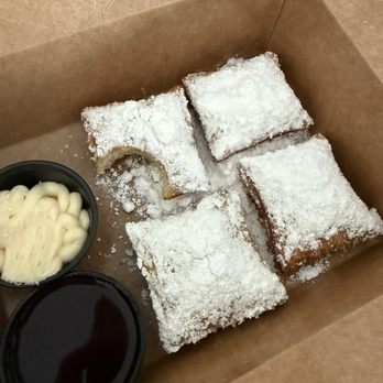 Beignets & Brew - Traditional beignets (4) with cream cheese and blueberry dipping sauce. - Coffee & Tea Near Me - Destin, Florida Beignets & Brew - Traditional beignets (4) with cream cheese and blueberry dipping sauce. - Coffee & Tea Near Me - Destin, Florida