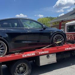 Taylors Express Towing - My Tesla with flat tire getting towed to the tires plus
