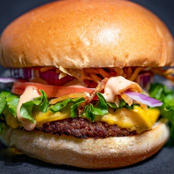 PINCHO FIU Graham Center - a hamburger with lettuce, tomato, and cheese - Latin American Near Me - Miami, Florida PINCHO FIU Graham Center - a hamburger with lettuce, tomato, and cheese - Latin American Near Me - Miami, Florida