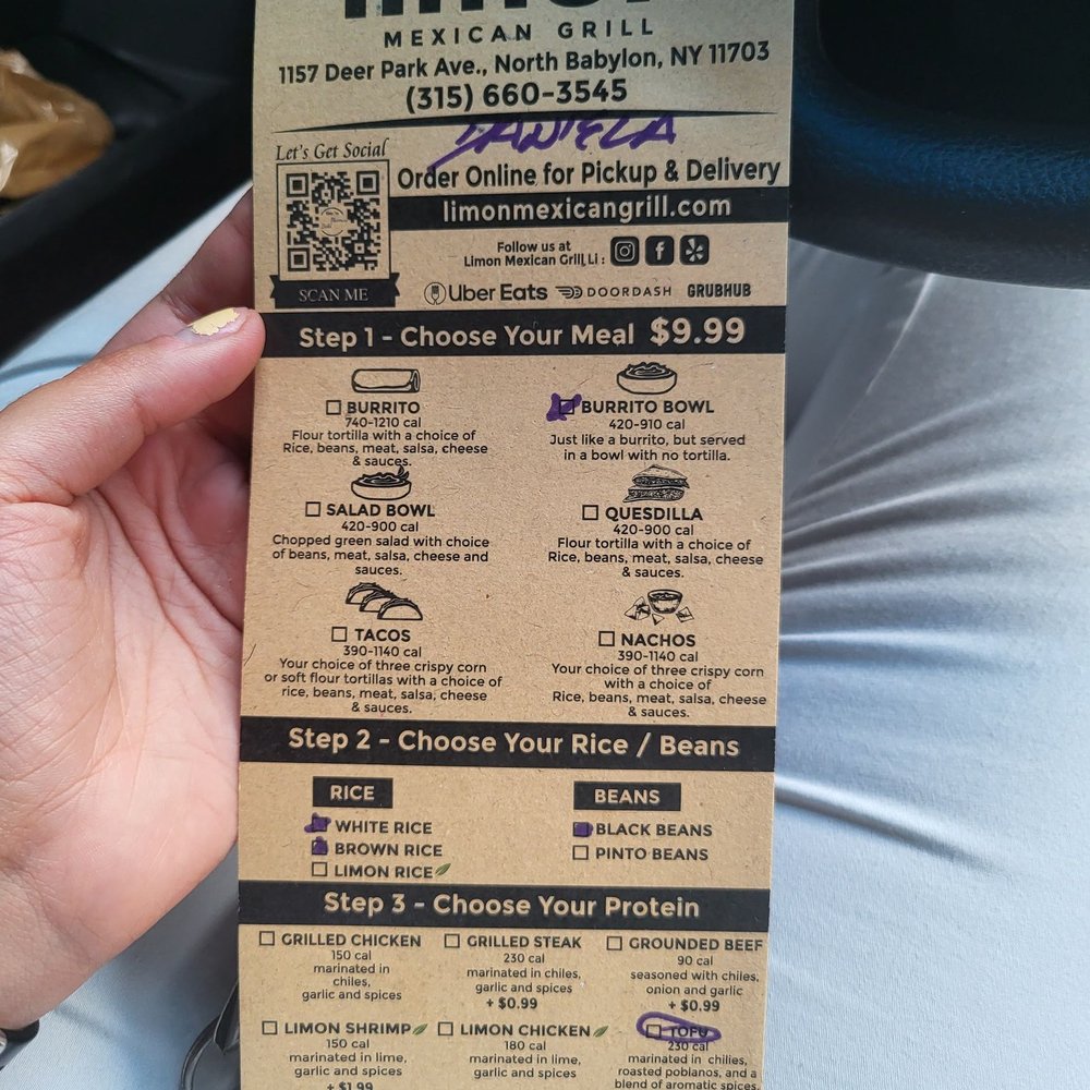 a hand holding a menu