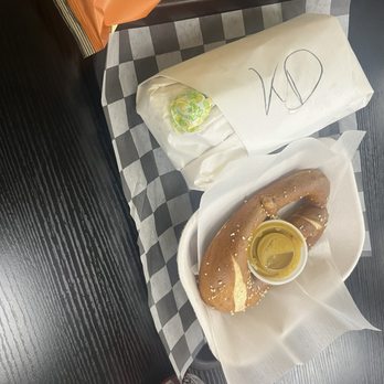 Fatbelly Pretzel - A wrapped, house turkey sandwich on a pretzel roll, and salted hand rolled pretzel with a honey mustard sauce on a tray. - Delis Near Me - Nashville, Tennessee Fatbelly Pretzel - A wrapped, house turkey sandwich on a pretzel roll, and salted hand rolled pretzel with a honey mustard sauce on a tray. - Delis Near Me - Nashville, Tennessee
