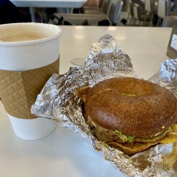 Poppy's Bagels - Turkey, avocado and egg on wheat bagel with cappuccino - Breakfast & Brunch Near Me - Newark, New Jersey Poppy's Bagels - Turkey, avocado and egg on wheat bagel with cappuccino - Breakfast & Brunch Near Me - Newark, New Jersey