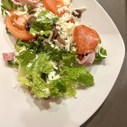 New York  Pizzeria - Antipasto Salad. Pepperoni, tomato wedges, olives, salami, ham, grated mozzarella cheese. Served with Italian dressing.