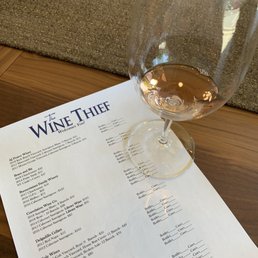 a glass of wine on a table a glass of wine on a table