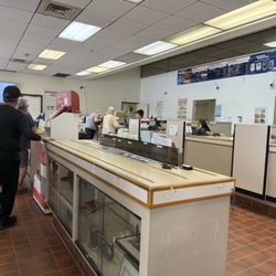 US Post Office - Loooooong line- half way into the next room. Only two staff