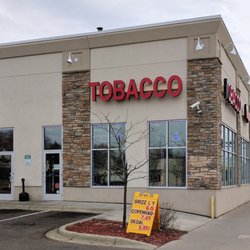 Midway Tobacco & Vapor - Storefront from large off-street parking.