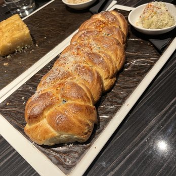 Plate - Garlic bread with black truffle butter - Cocktail Bars Near Me - Kansas City, Missouri Plate - Garlic bread with black truffle butter - Cocktail Bars Near Me - Kansas City, Missouri