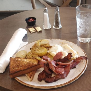 The Yard - American Breakfast - Pictured is bacon, sausage, toast, golden potatoes, and two eggs over medium (can be any style). - Southern Near Me - Birmingham, Alabama