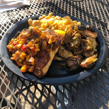 Fishbones - a plate of food on a table - New American Near Me - Greensboro, North Carolina