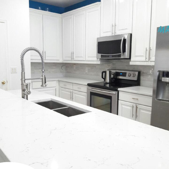 White Quartz Countertop With Glass Tile Backsplash Installed By