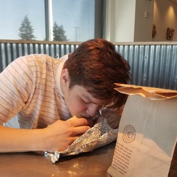Chipotle Mexican Grill - Bro chowing down on his burrito - Mexican Near Me - Happy Valley, Oregon