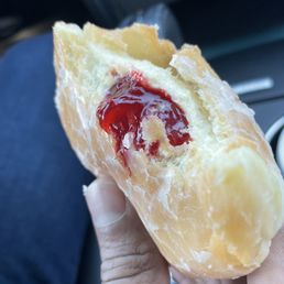 Glazed donut with raspberry filling Glazed donut with raspberry filling