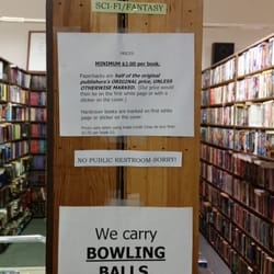Jerry Cloutier's Used Books - Pricing information and view of two aisles of books.
