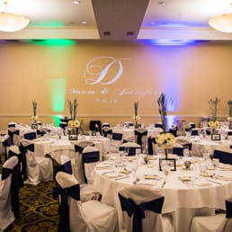 White satin chair covers with navy sashes- photo by Top Shelf Photo, at Crowne Plaza San Diego. Gobo and lighting by Playtime Attractions White satin chair covers with navy sashes- photo by Top Shelf Photo, at Crowne Plaza San Diego. Gobo and lighting by Playtime Attractions