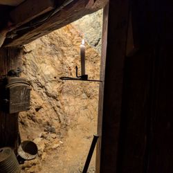 Chollar Mine Tours - Candle inside the mine to demonstrate the darkness without it