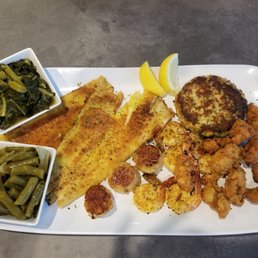 Captain's Platter: Grilled Flounder, Sea Scallops  Shrimp, Crab cake, fried oysters, green beans and collards.