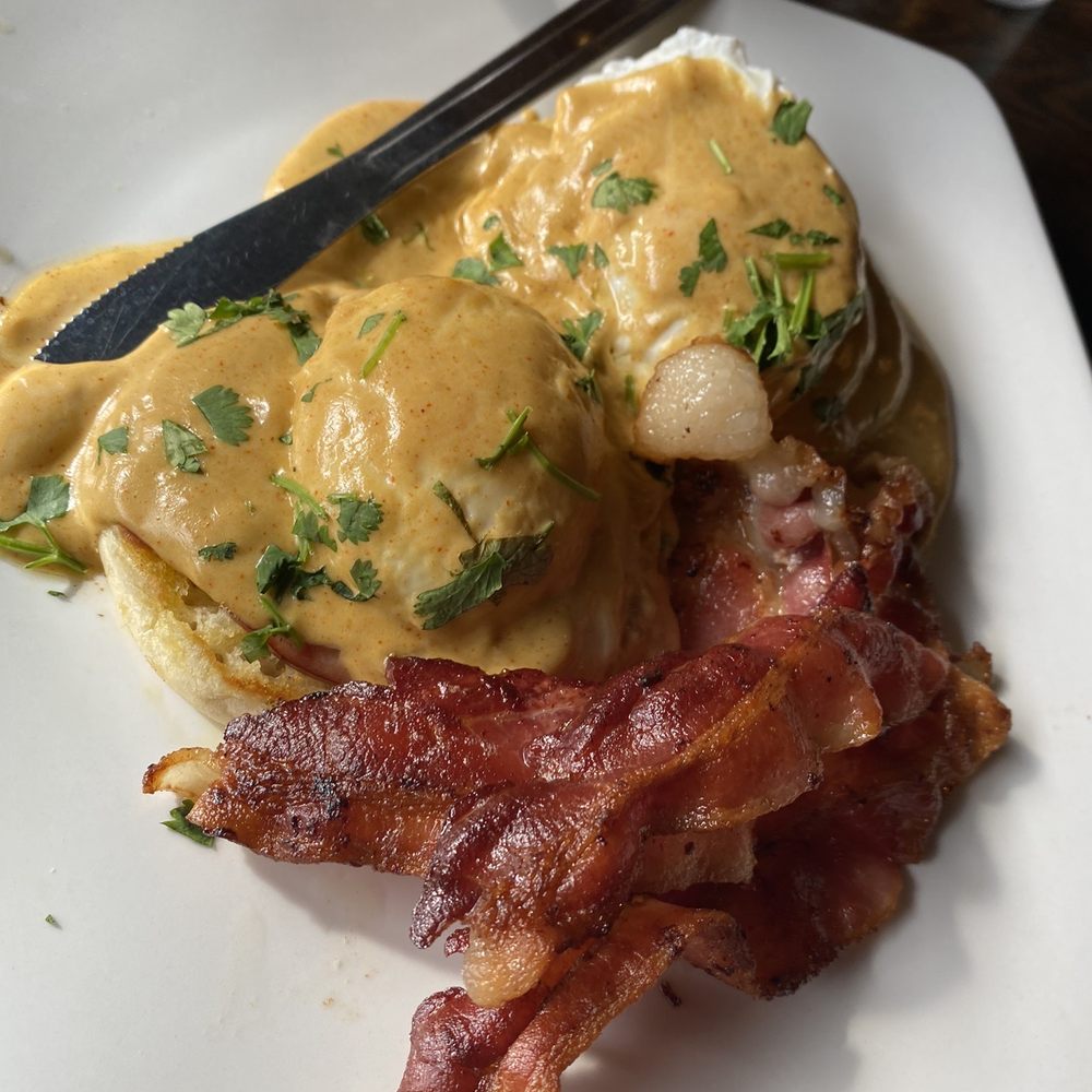Tortuga Jack's - Eggs Benedict with Mexican Hollandaise sauce and bacon. - Mexican Near Me - Jekyll Island, Georgia Tortuga Jack's - Eggs Benedict with Mexican Hollandaise sauce and bacon. - Mexican Near Me - Jekyll Island, Georgia