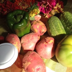 Farmer's Pavilion at The Friendly Market - Green tomatoes, cucumbers, green pepper, potatoes, jalapeño strawberry jelly, and flowers.  My picks for today.