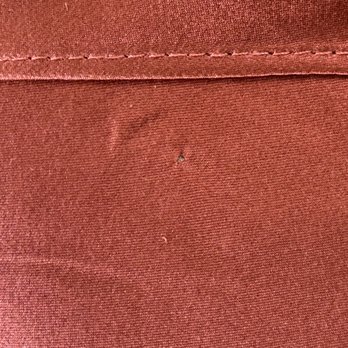 Elite Cleaners - One of the holes they put through the fabric to hang the skirt. - Dry Cleaning Near Me - Dana Point, California Elite Cleaners - One of the holes they put through the fabric to hang the skirt. - Dry Cleaning Near Me - Dana Point, California