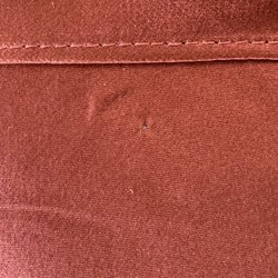 Elite Cleaners - One of the holes they put through the fabric to hang the skirt.