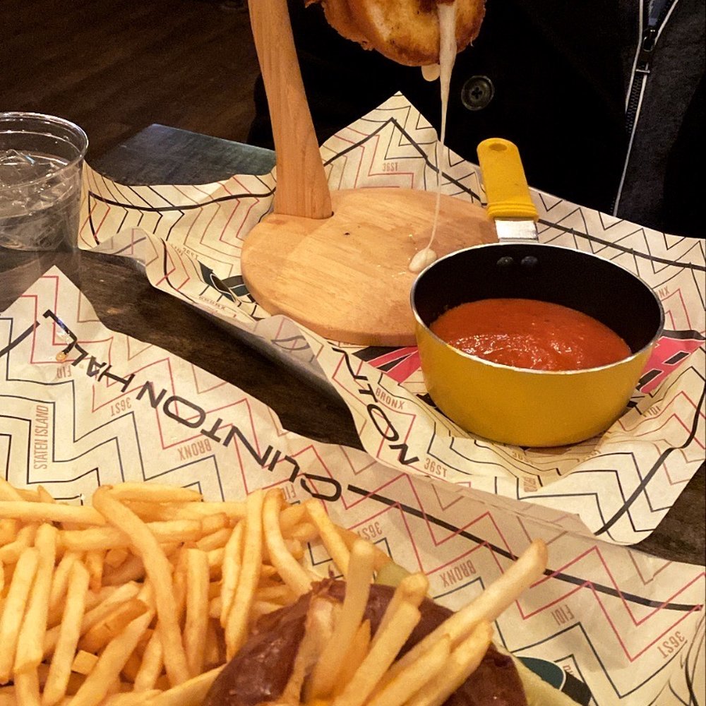 a person eating a burger and fries a person eating a burger and fries