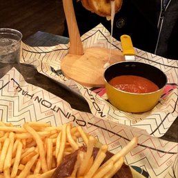 a person eating a burger and fries a person eating a burger and fries