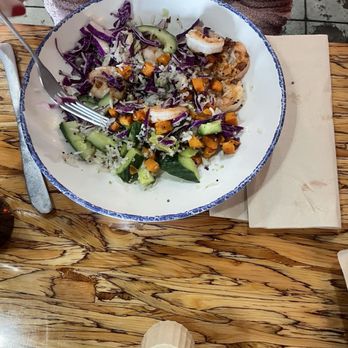 Slapfish - Shrimp bowl, yum! - A seafood salad featuring shrimp, cucumber slices, purple cabbage, and diced sweet potatoes served on a white plate with a blue rim. - Seafood Near Me - Albuquerque, New Mexico