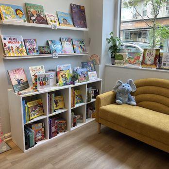 Moon and Back - A corner of the shop with a yellow couch - Bookstores Near Me - Medford, Massachusetts Moon and Back - A corner of the shop with a yellow couch - Bookstores Near Me - Medford, Massachusetts