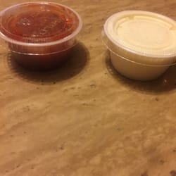 Moe's Southwest Grill - Moe's itty bitty container of queso. Same size as the containers used for the salsa bar.