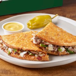 Parmesan crusted flatbread-style sandwich with Philly sauce, cheese, steak, onions and green peppers...