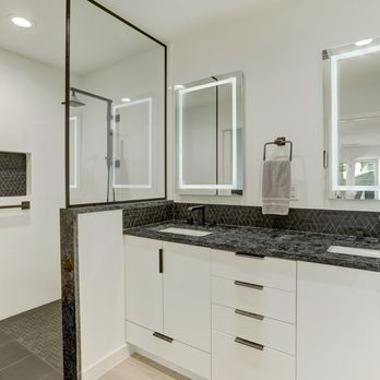 Adams Company - a bathroom with two sinks and a shower - General Contractors Near Me - Austin, Texas Adams Company - a bathroom with two sinks and a shower - General Contractors Near Me - Austin, Texas