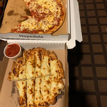 Crossroads Pizza - a pizza in a box with a slice taken out of it - Pizza Near Me - Carrollton, Ohio Crossroads Pizza - a pizza in a box with a slice taken out of it - Pizza Near Me - Carrollton, Ohio