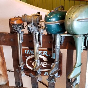 The Cove - A variety of collectable boat motors mounted by the bar. - Seafood Near Me - Leland, Michigan