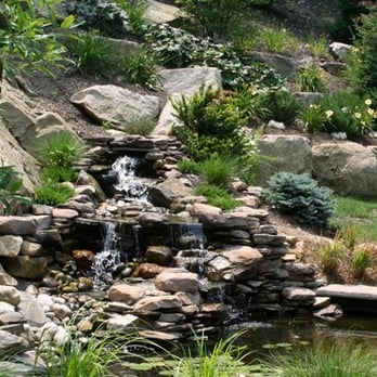 Designer Landscaping - a waterfall in a garden - Landscaping Near Me Designer Landscaping - a waterfall in a garden - Landscaping Near Me
