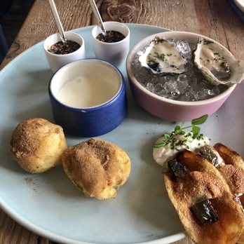 Rich Table - Oysters on the half, sardine chip horseradish creme fraiche, dried porcini doughnuts raclette with cheese dip and savory panna cotta. - New American Near Me - San Francisco, California Rich Table - Oysters on the half, sardine chip horseradish creme fraiche, dried porcini doughnuts raclette with cheese dip and savory panna cotta. - New American Near Me - San Francisco, California