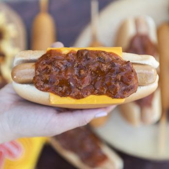 Wienerschnitzel - a hand holding a chili dog - Hot Dogs Near Me - Ridgecrest, California Wienerschnitzel - a hand holding a chili dog - Hot Dogs Near Me - Ridgecrest, California