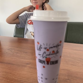 Crepe & Creme - a woman sitting at a table with a drink - Ice Cream & Frozen Yogurt Near Me - Cookeville, Tennessee