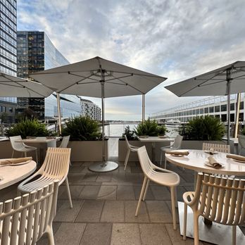 SAVR - tables and chairs with umbrellas on a rooftop - American Near Me - Boston, Massachusetts SAVR - tables and chairs with umbrellas on a rooftop - American Near Me - Boston, Massachusetts