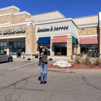 Caribou Coffee - a man walking in a parking lot - Coffee & Tea Near Me - Chaska, Minnesota