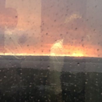Aerie Restaurant & Lounge - Rainy weather with sunset in the West over the Grand Traverse Bay. - New American Near Me - Acme, Michigan