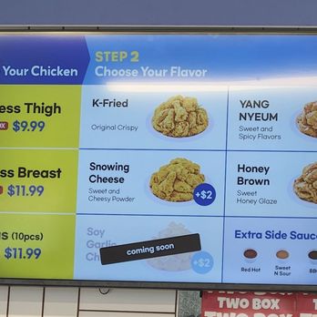 Two Box - The menu board lists chicken options such as boneless thigh, boneless breast, and wings, with prices and labels like 'ONE BOX' and specific flavor choices like K-Fried and Snowing Cheese. It also features additional flavor options with a '+$2' surcharge and a section for extra side sauces priced at $1.99, including flavors like Red Hot and BBQ. A sticker indicates a 'coming soon' item. - Korean Near Me - Englewood, New Jersey