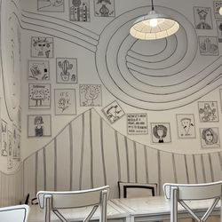 Creperie Mirakulum - Seating area with new line art motif.