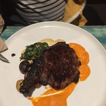 Tavern - Bone in ribeye with collards and baby potatoes with a red pepper purée sauce! - New American Near Me - Coronado, California Tavern - Bone in ribeye with collards and baby potatoes with a red pepper purée sauce! - New American Near Me - Coronado, California