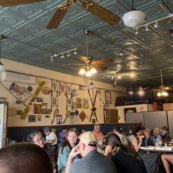 Sven & Ole's - Full dining room but unclean. Sticky tables, overrunning  trash bins and tons of flies.