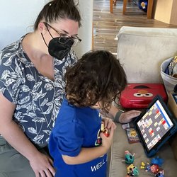 North Star Speech and Language Pathology Center - My son and Katherine using the AAC device