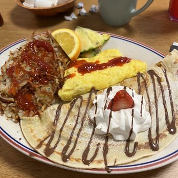 Tin Can Cafe - Large Appetite with a strawberry banana crepe, scrambled eggs with cheese, hash browns and fruit. - Breakfast & Brunch Near Me - Hudson, Florida